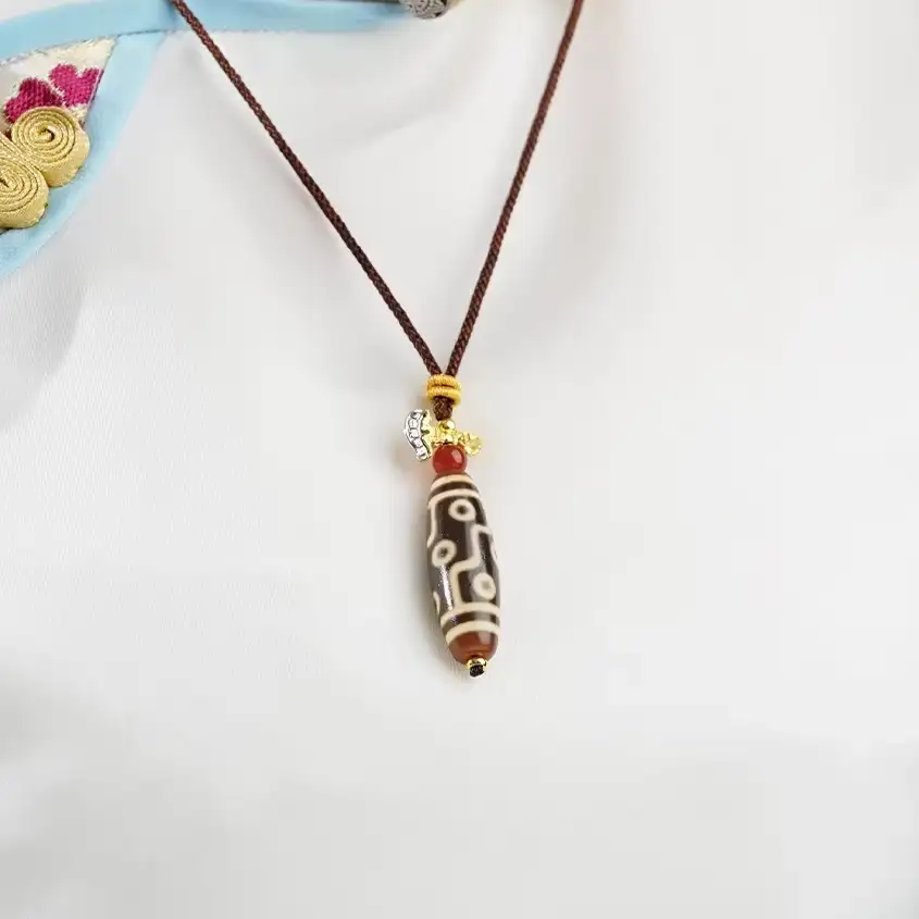 Authentic Tibetan Hand-Braided Dzi Bead Amulet Necklace – Sacred Talisman for Harmony, Luck, and Positive Energy - Lifestyle Display