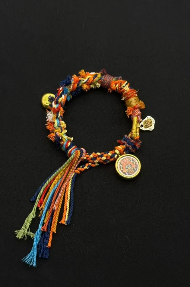 Himalayan Blessing: Handwoven Tibetan Lucky Knot Bracelet with Sacred Charms